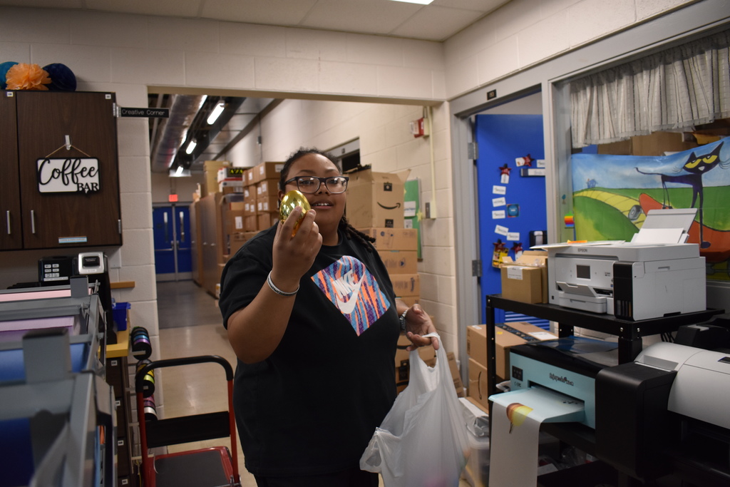 a staff member showing us a golden egg