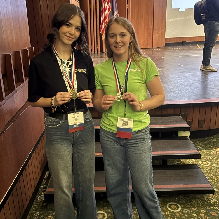 two students posing and smiling 