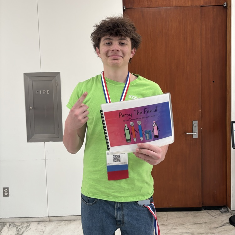a student posing with his materials 