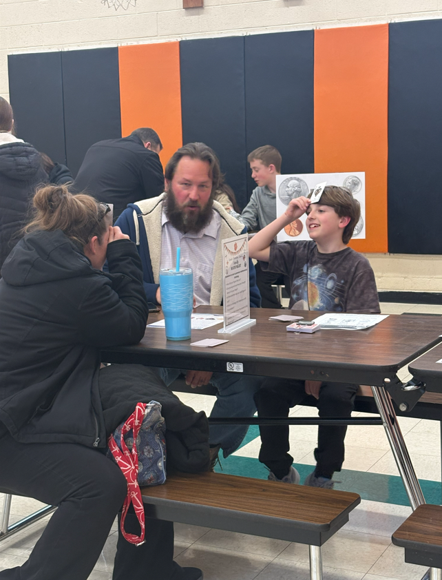 A family playing a game in the gym