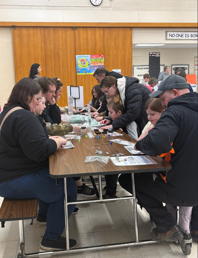 families playing with money for math night