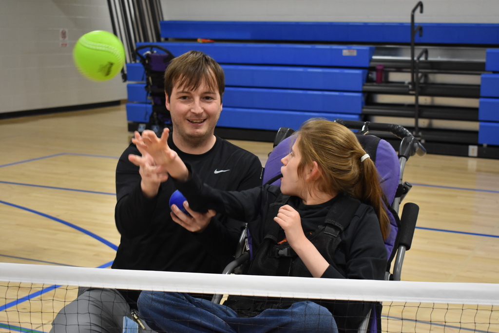 A student released a ball with the help of her teacher