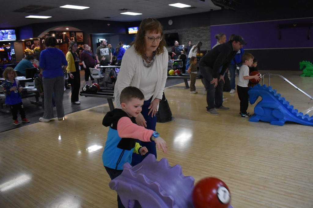 A student bowling with his grandma