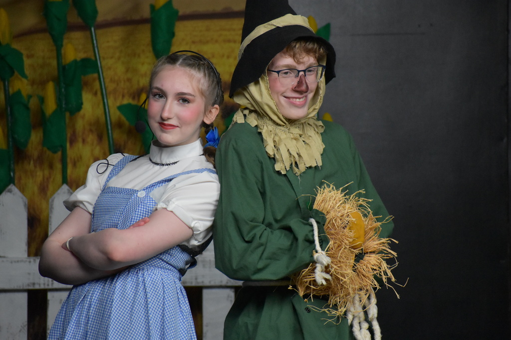 Dorothy and Scarecrow finishing a scene with a pose and smile