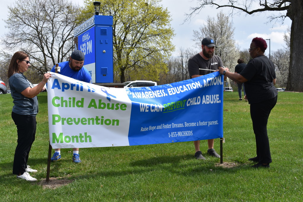 Ken and Will placing the sign in the ground