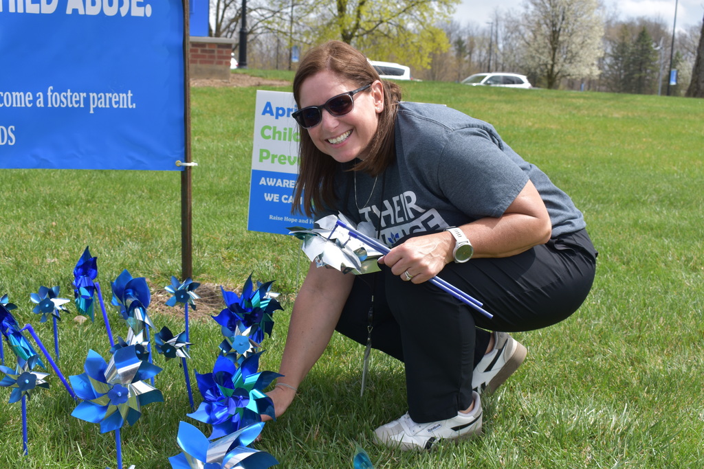Kelly placing pinwheels in the ground