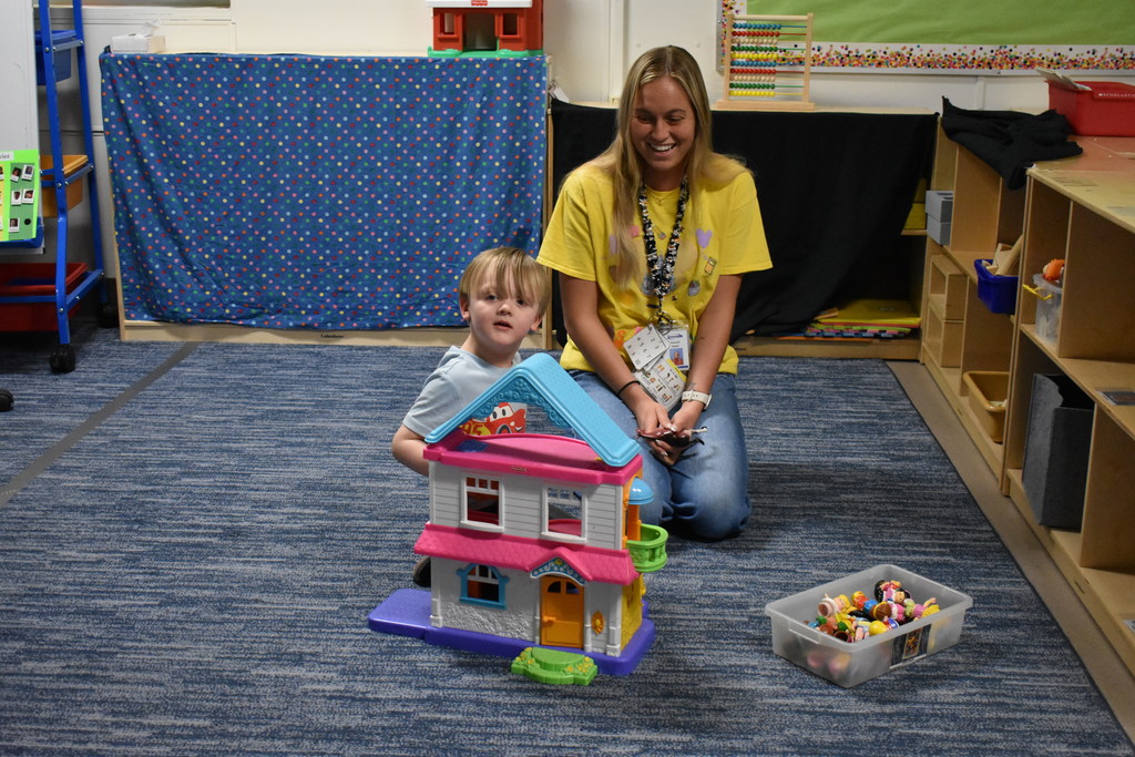A teacher and prospective preschooler enjoying an activity