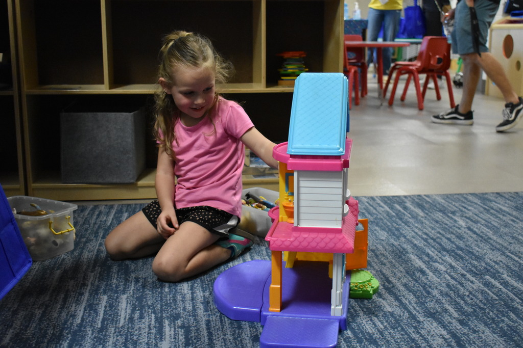 A prospective preschooler playing with a toy