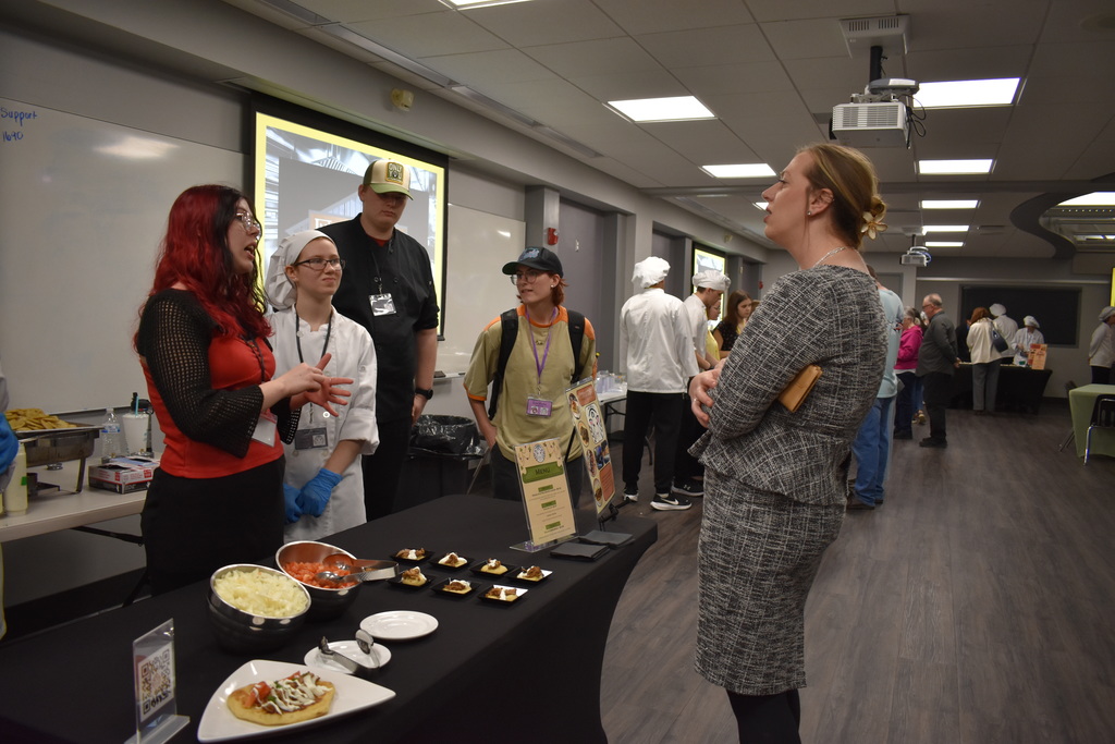 A team explaining their restaurant and menu to a visitor