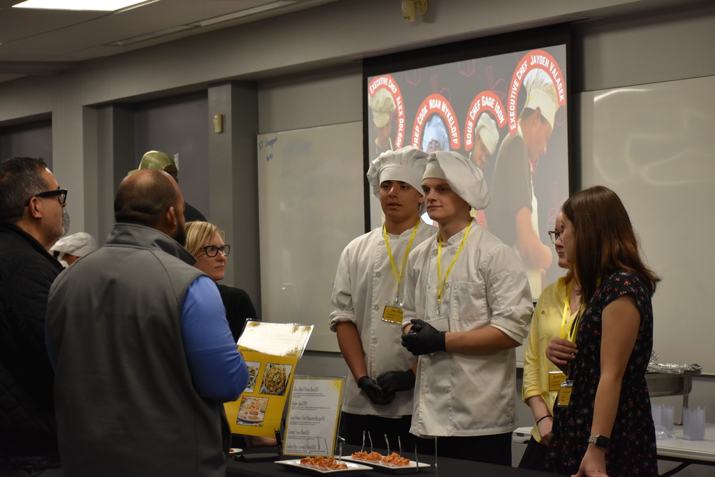 A team chatting with visitors at the event