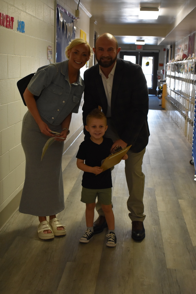 A family posing the hallway as they were on their scavenger hunt
