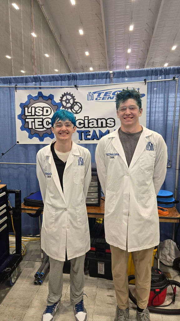 two students in lab coats and blue hair