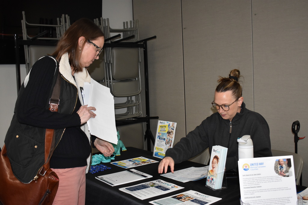 A vendor speaking to an educator at their table