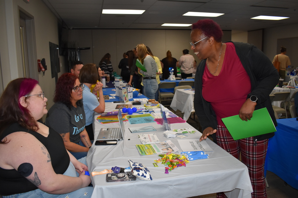 People at the event chatting at tables with vendors