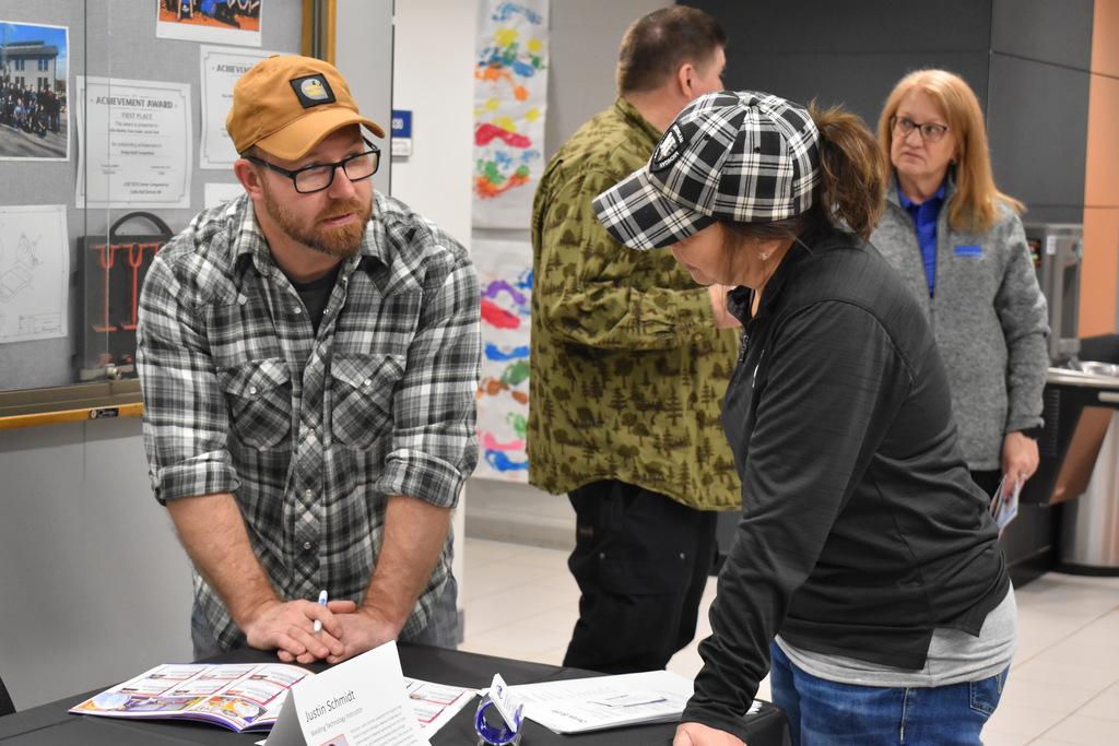 An instructor speaking with an employer and going through the Reverse job Fair Program
