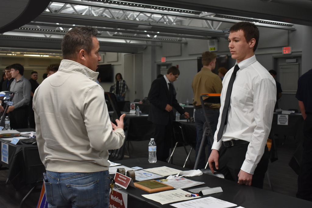 A student and employer chatting at Reverse Job Fair