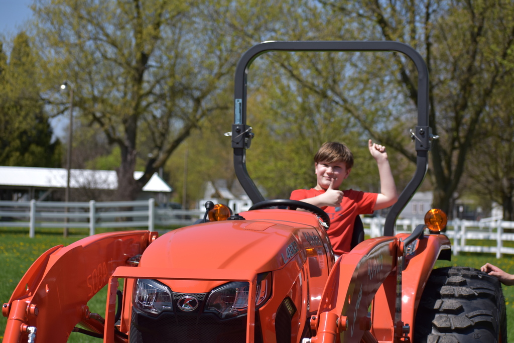 A young student sitting on a tractor