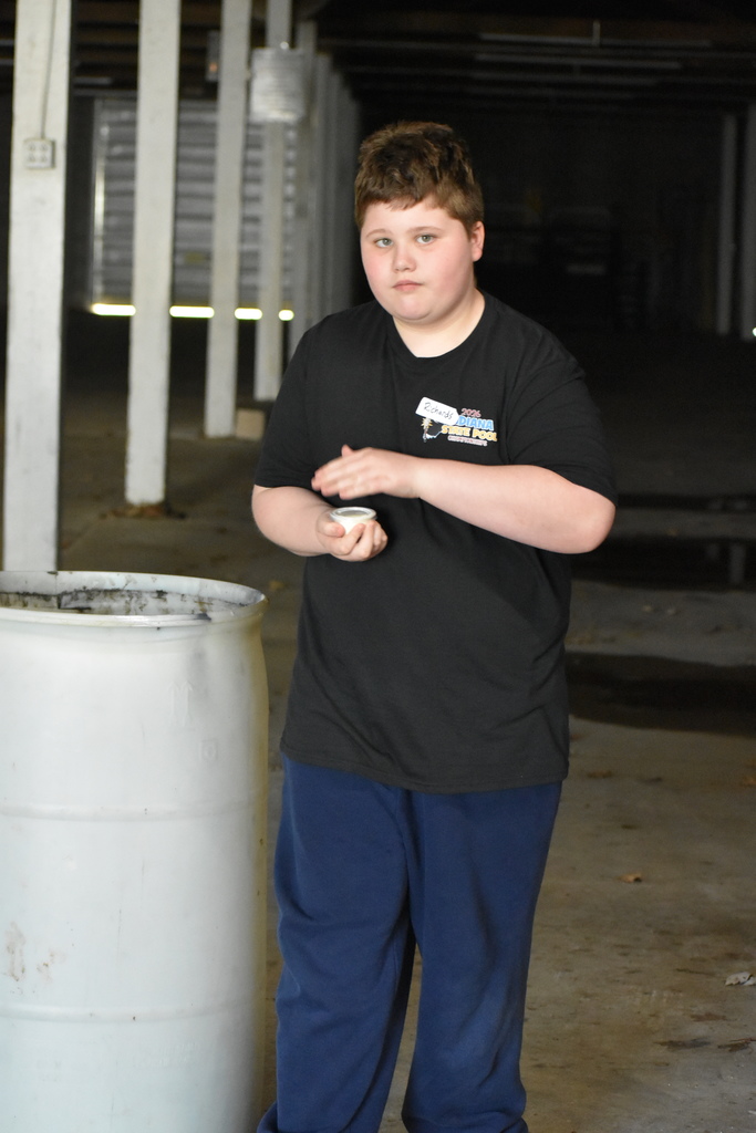 A young student shaking his butter