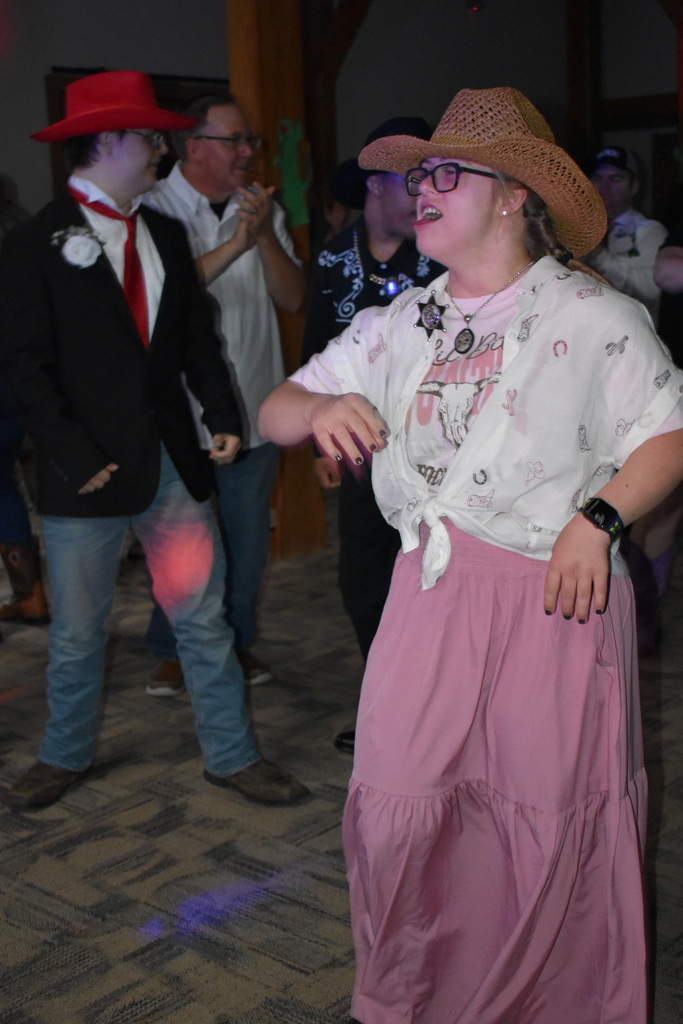 A student dancing while others dance in the background around her