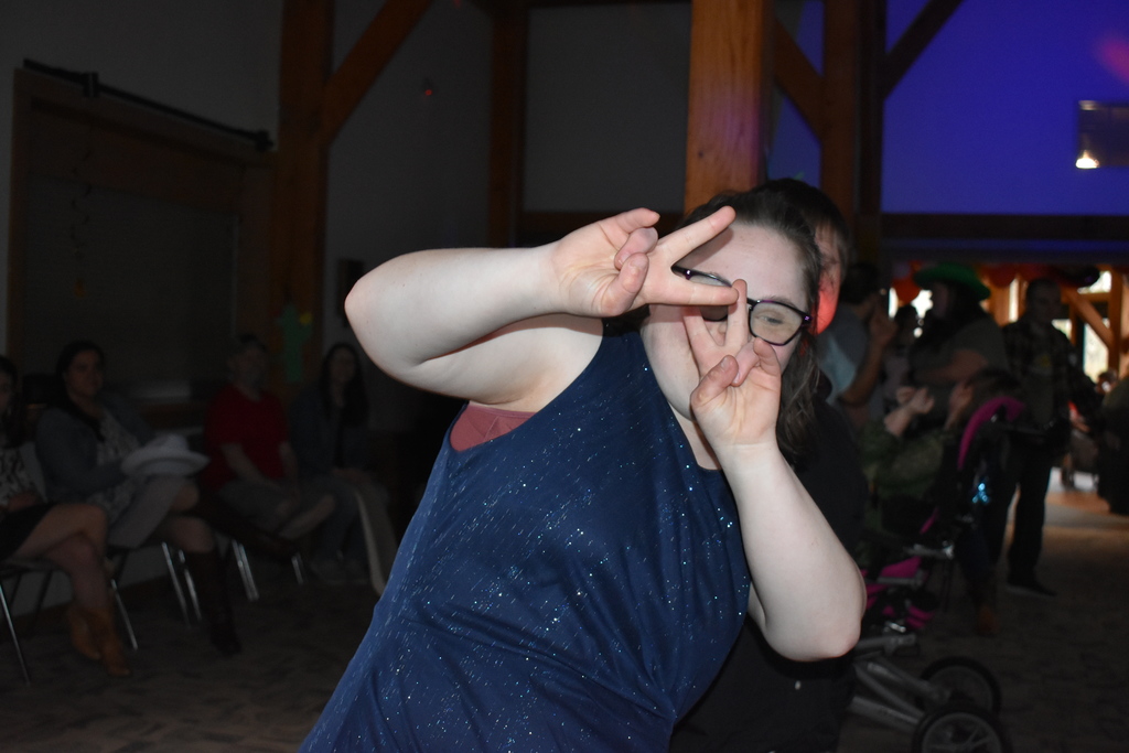 A student giving the peace sign and dancing