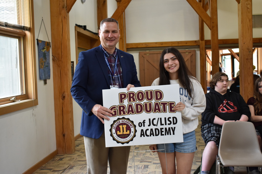 A student receiving her sign from superintendent Mark Haag