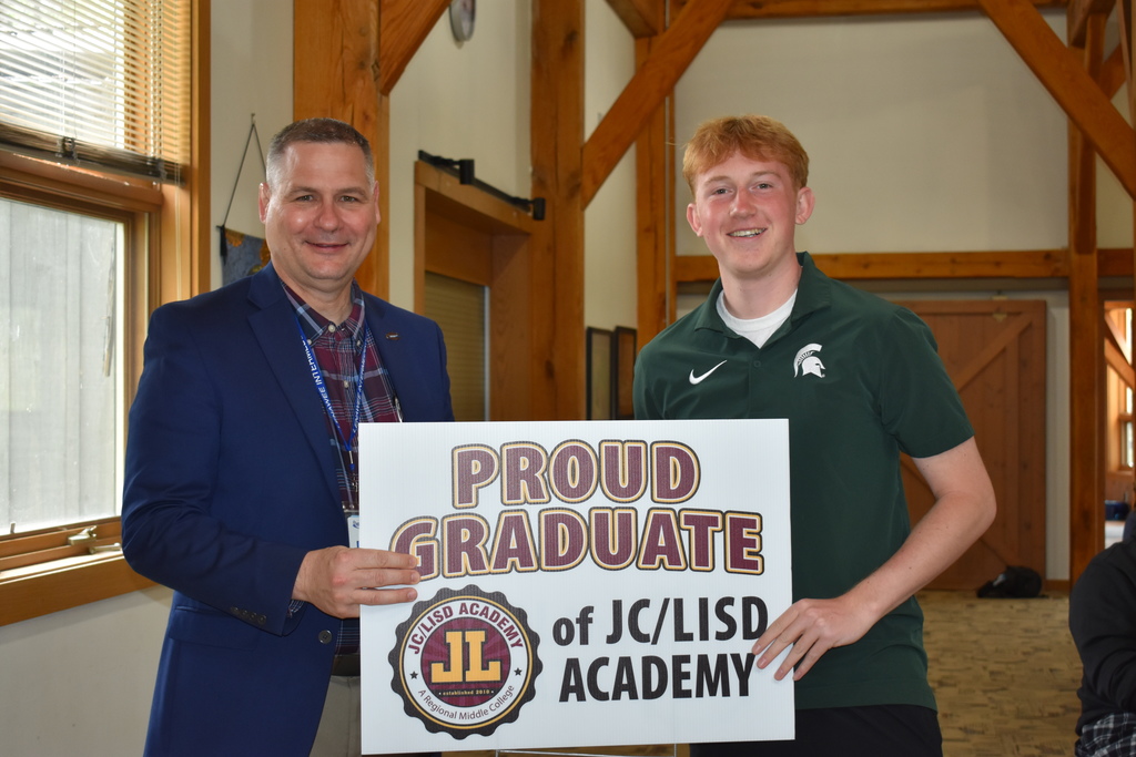 A student receiving his sign from superintendent Mark Haag