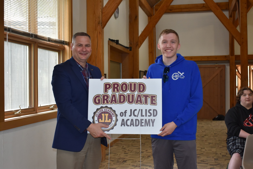 A student receiving his sign from superintendent Mark Haag