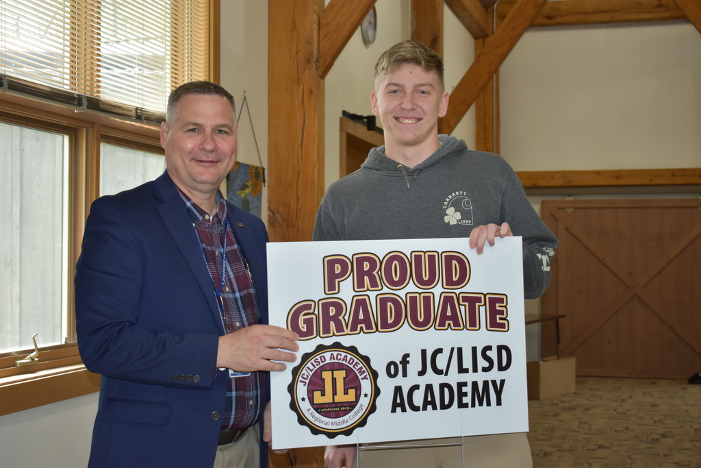A student receiving his sign from superintendent Mark Haag