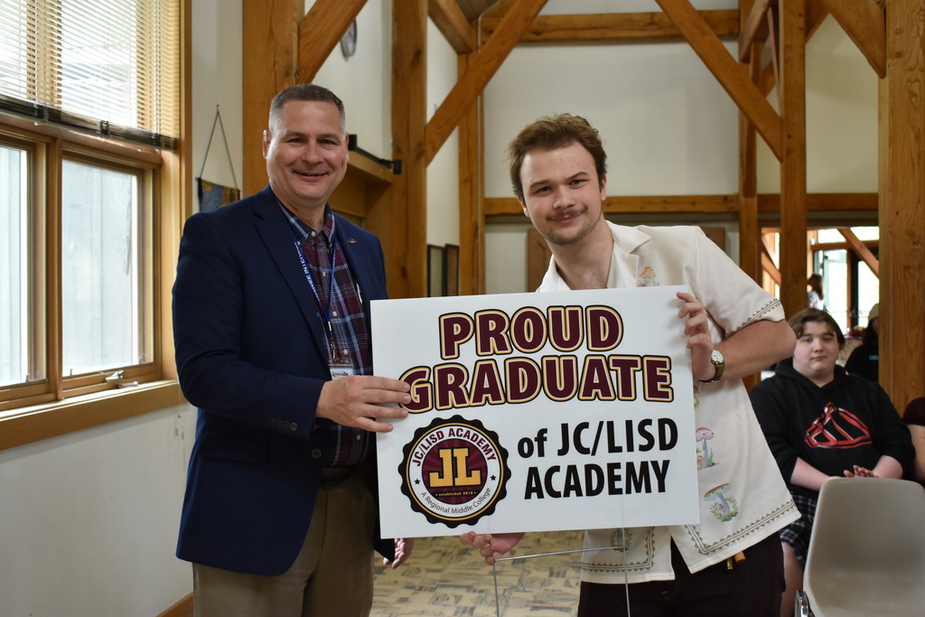 A student receiving his sign from superintendent Mark Haag