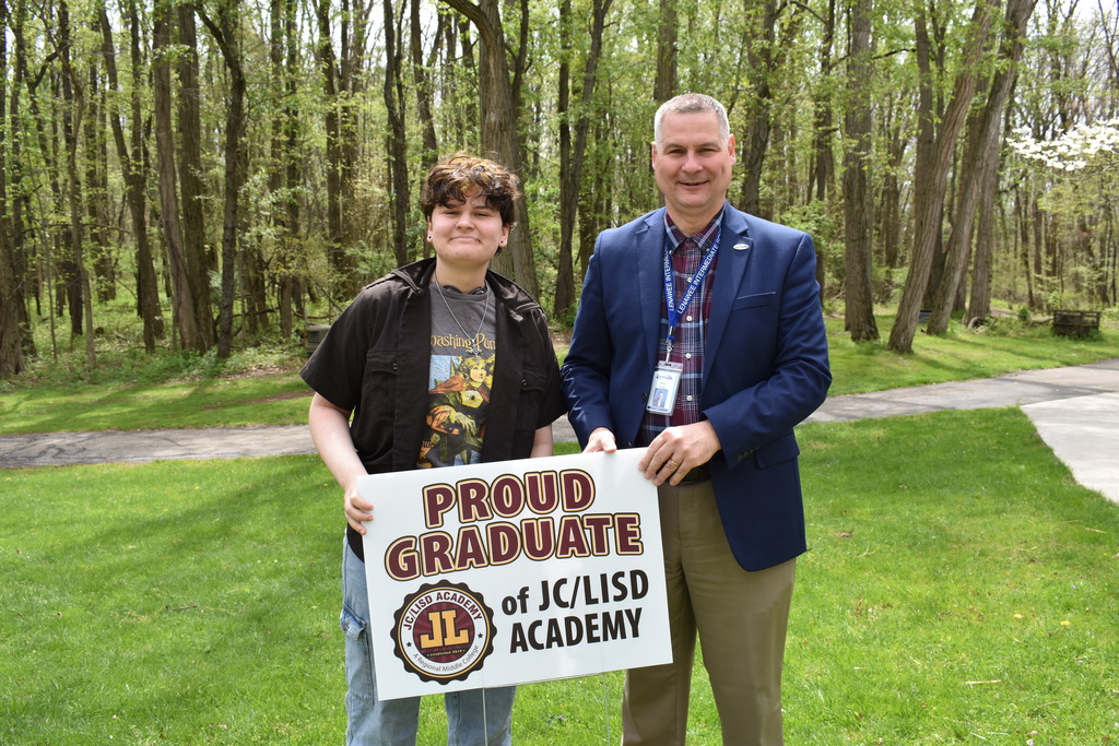 A student receiving his sign from superintendent Mark Haag