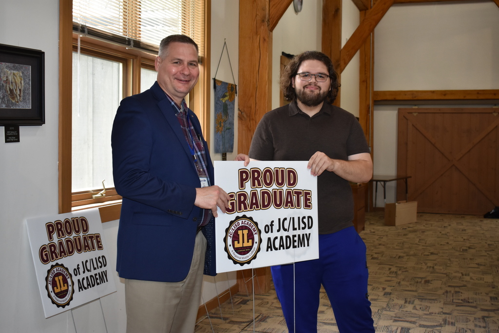 A student receiving his sign from superintendent Mark Haag