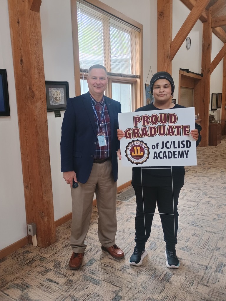 A student receiving their sign from Mark Haag