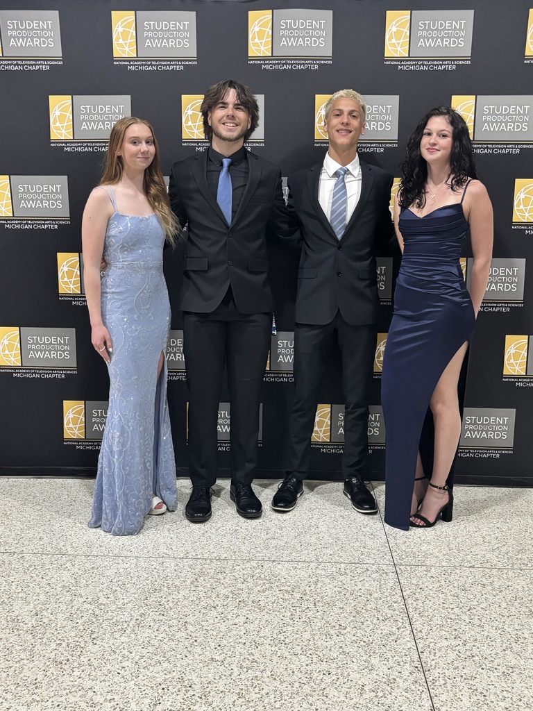 Four students posing together at the event