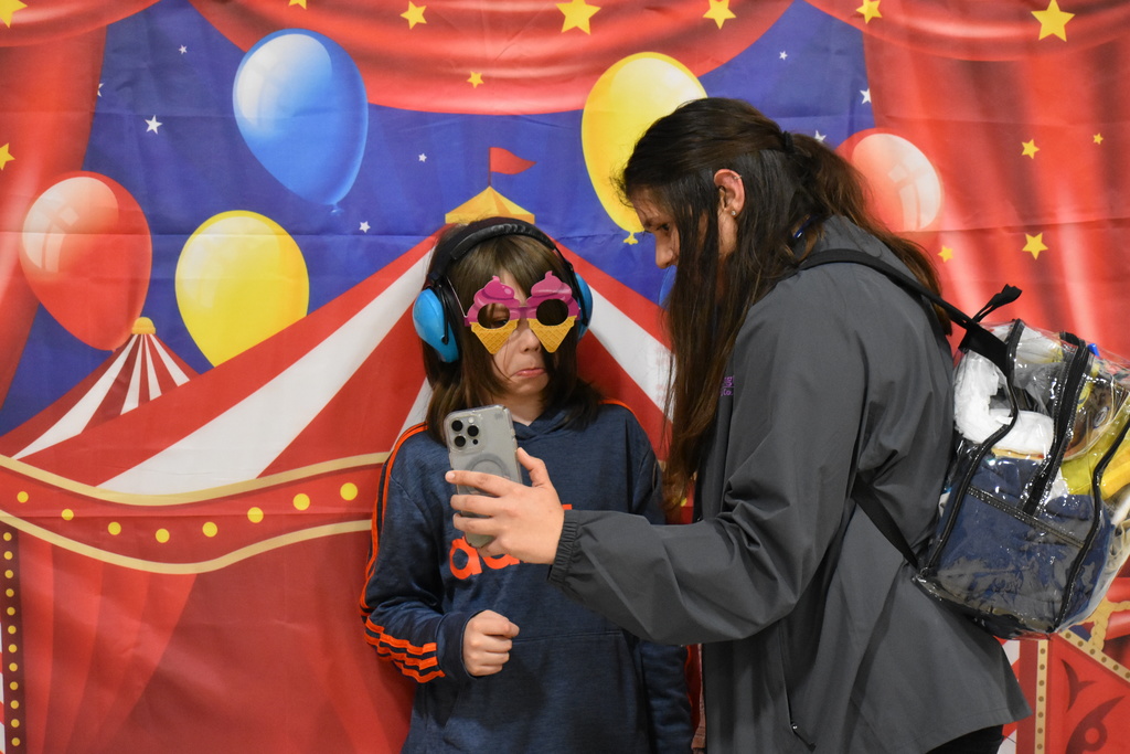 A student in a photobooth with their instructor