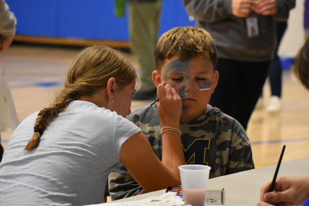 A student getting his face painted