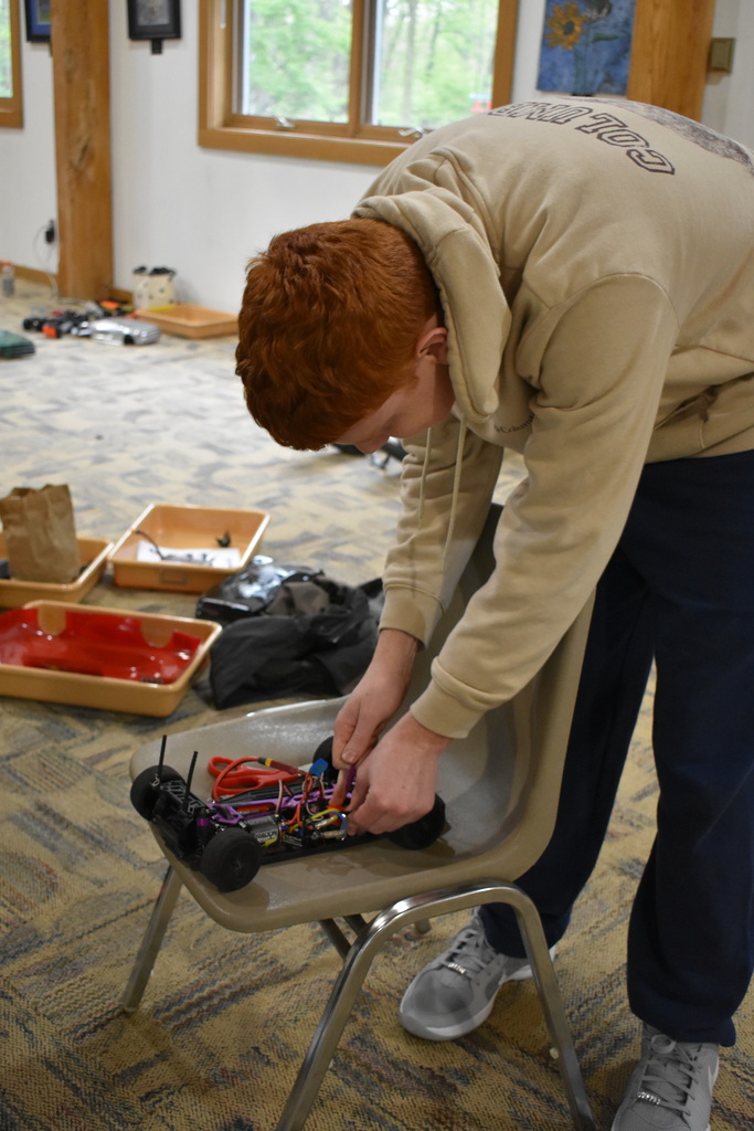 a student working on his car before the race