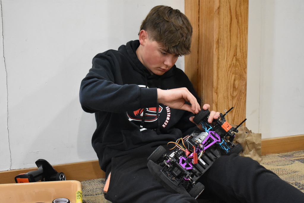 A student working on his car before the race