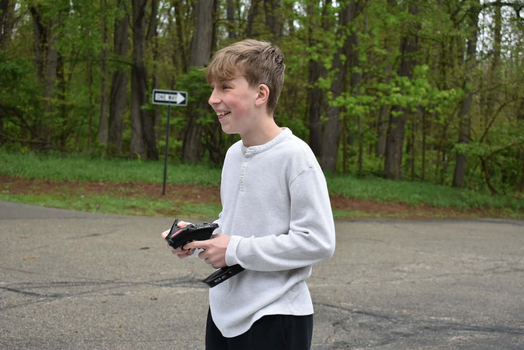 A student smiling and racing his car