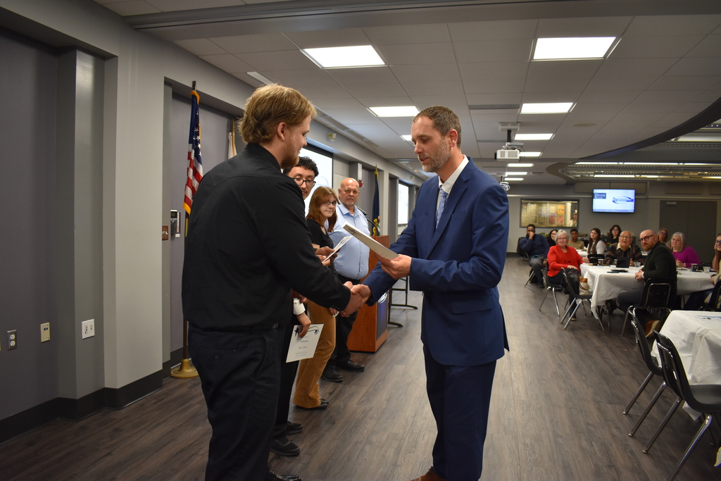 The winner receiving his award from his instructor