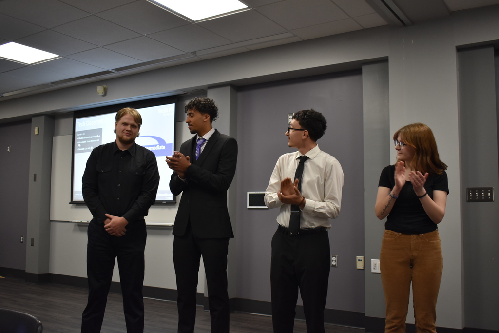 The candidates clapping as the winner was announced