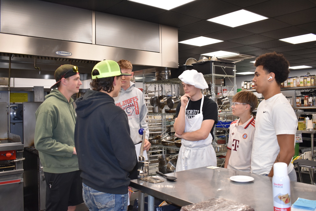 A team getting feedback from judges about their dish