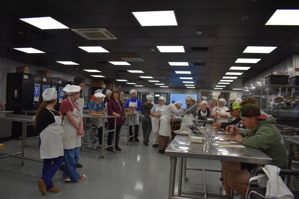 The judges trying a dish while other look on 