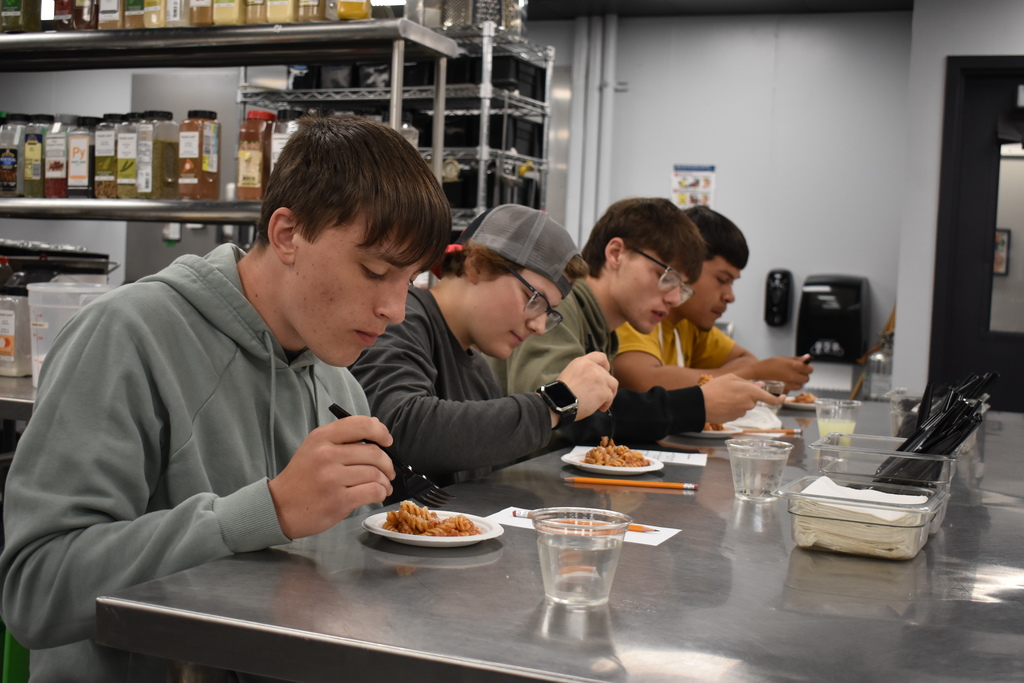 The four am judges trying a dish