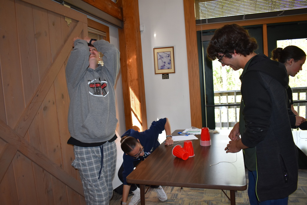 Students reacting to their tower falling over