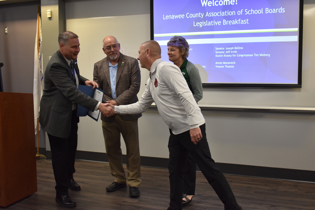 Mark Haag shaking Scott Salow's hand