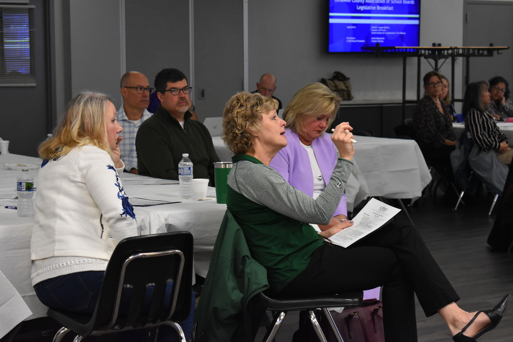 A superintendent asking a question during the legislative breakfast