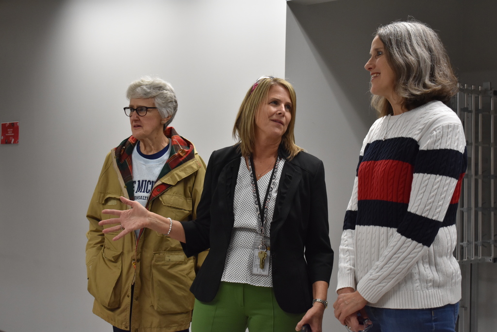Jenny Heath giving a tour to a NASA employee and her mother