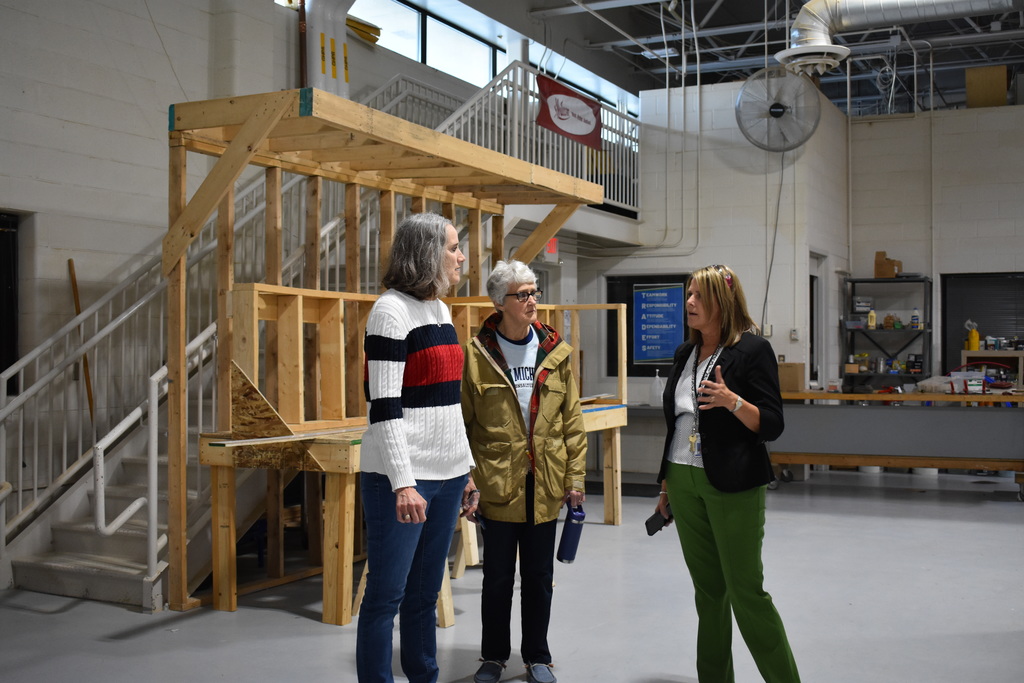 Jenny Heath giving a tour to a NASA employee and her mother