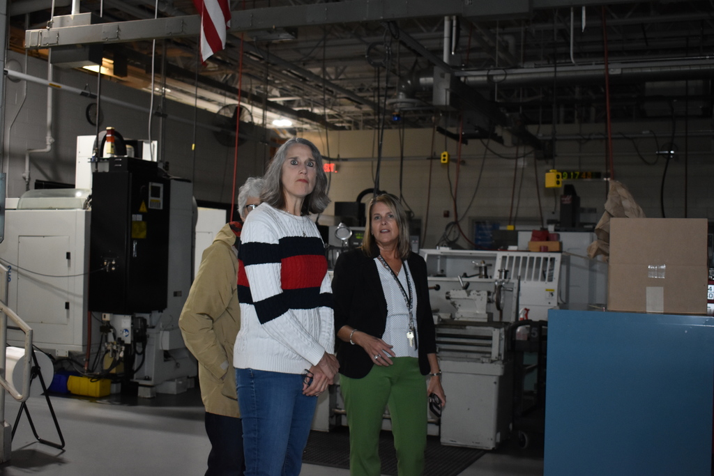 Jenny Heath giving a tour to a NASA employee and her mother