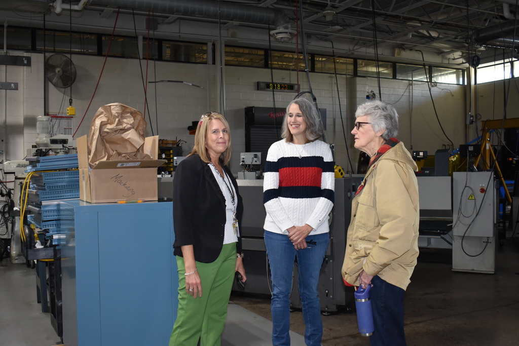 Jenny Heath giving a tour to a NASA employee and her mother